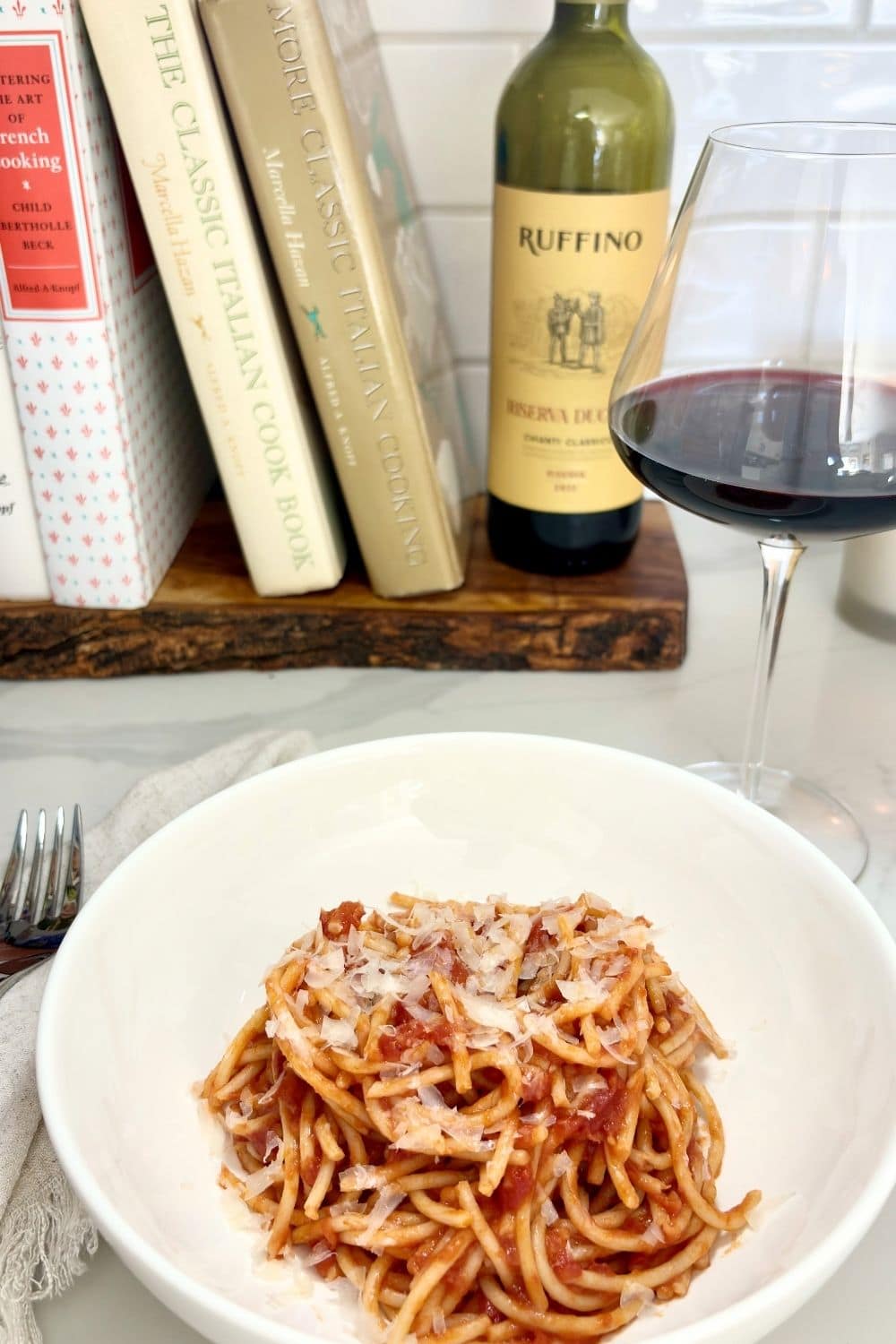 Spaghetti with tomato sauce served with a glass of Chianti wine for an Italian food and wine pairing.