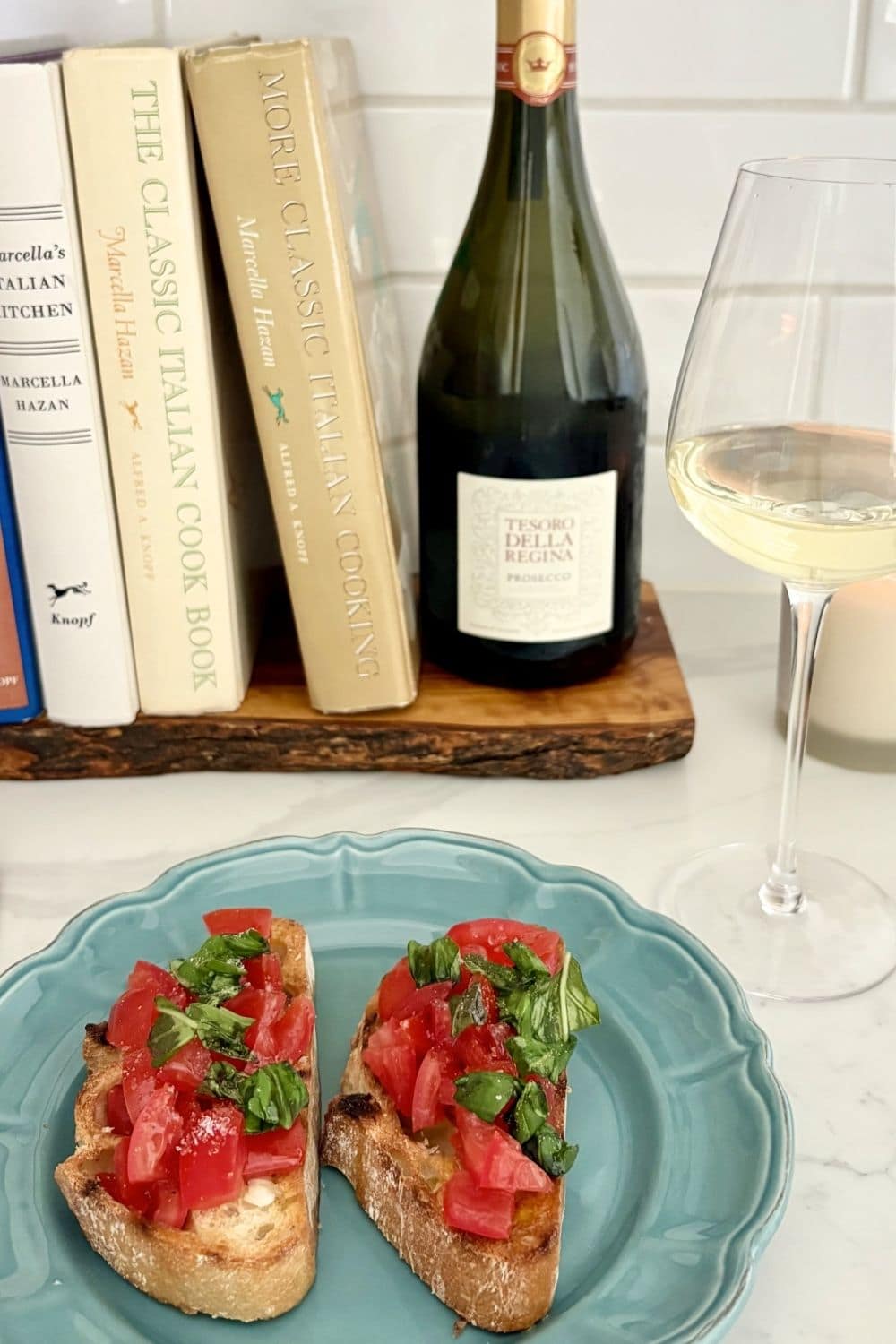 Bruschetta al pomodoro served with a glass of Prosecco for an Italian appetizer and wine pairing.