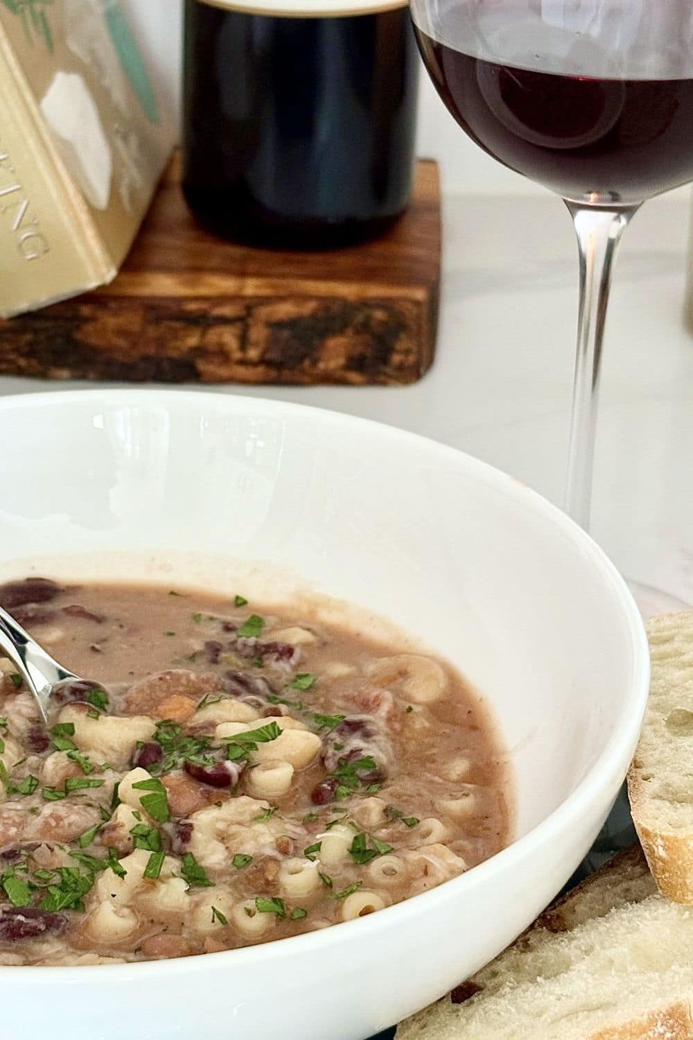 Pasta e fagioli soup with beans and small pasta served with bread and a glass of red wine