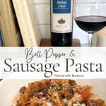 Bell pepper and sausage pasta served with a glass of red wine and cookbook in the background