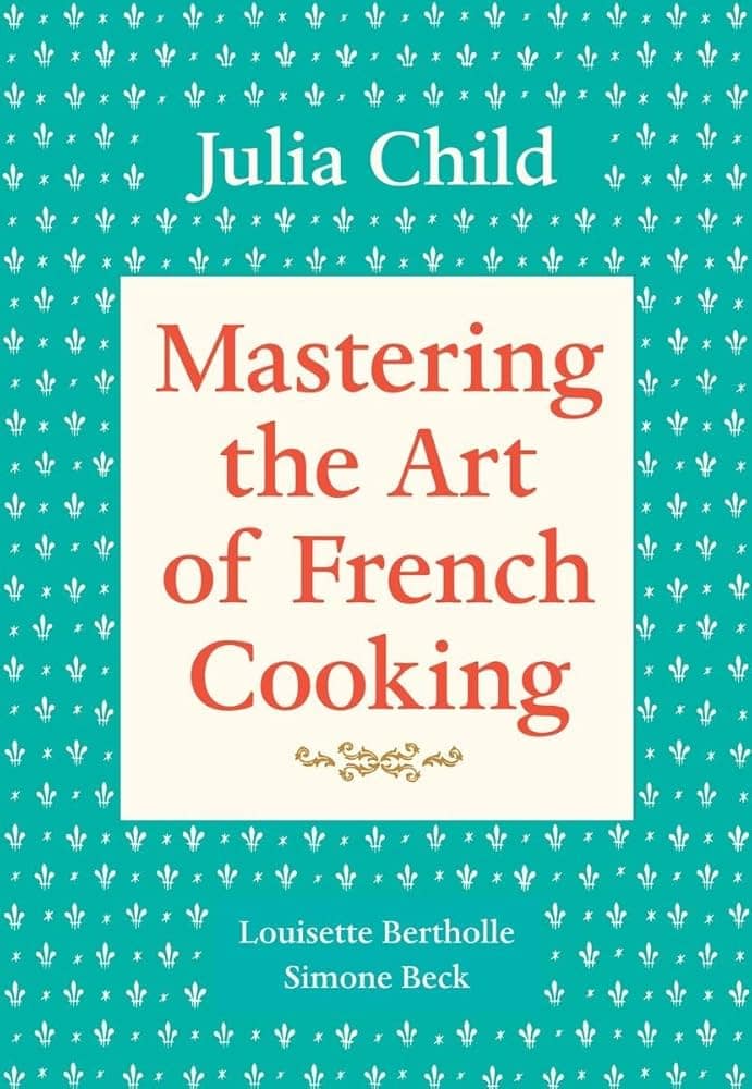 Mastering the Art of French Cooking by Julia Child cookbook cover with teal patterned background and red title text